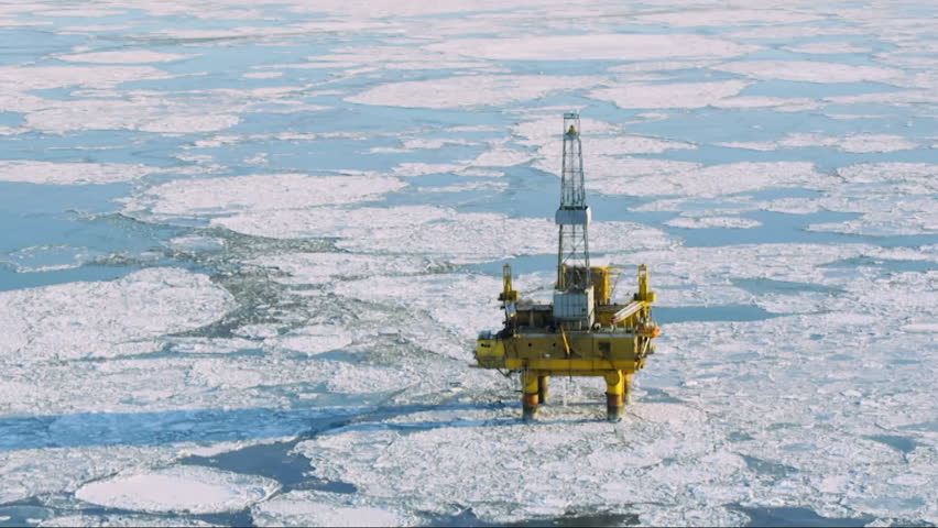 Aerial view of a large oil drilling platform operating in a frozen arctic sea