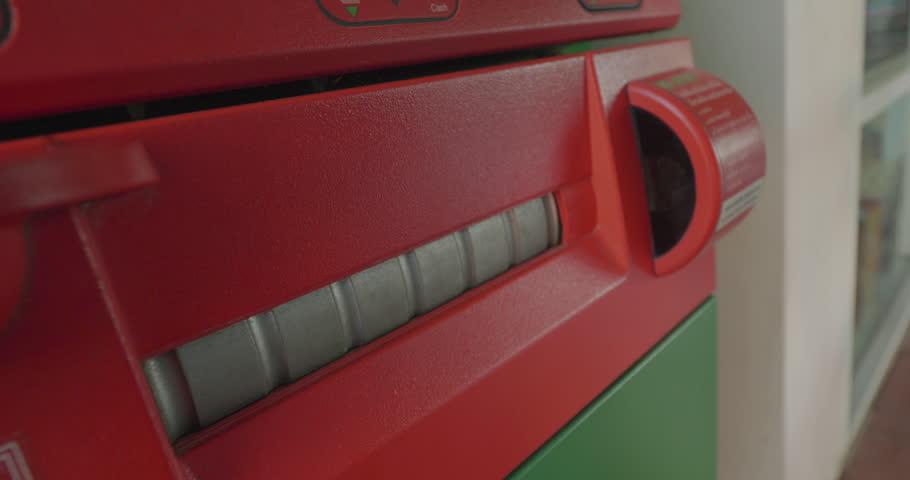 Closeup shot of hands taking money from an ATM machine
