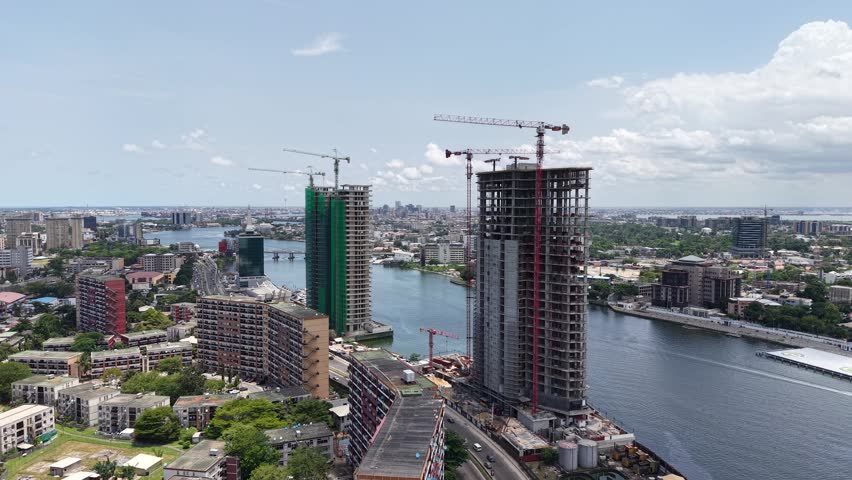 Aerial view of urban construction and bridge development over a river.