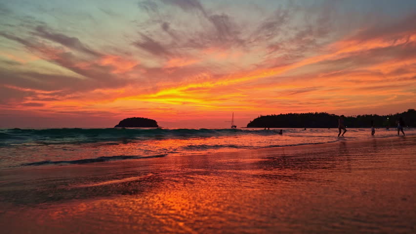 Stunning tropical beach sunset with glowing orange skies, gentle ocean waves, and peaceful island silhouettes creating a serene coastal atmosphere.