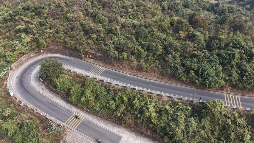 Scenic winding hairpin road through the green hills of Purulia, West Bengal, India.