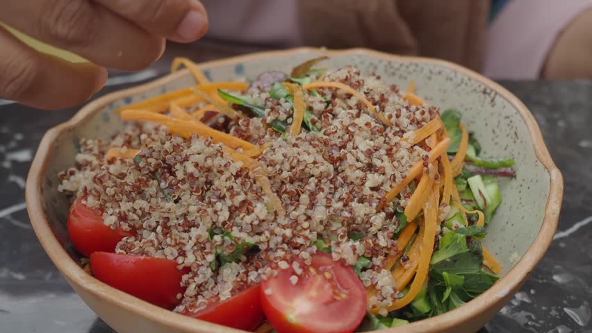 Preparing a fresh quinoa salad with vibrant ingredients