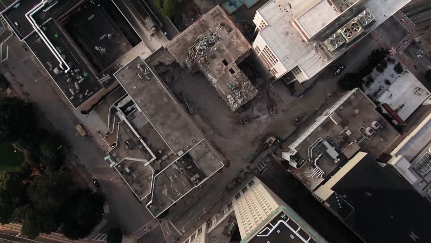 Drone top view of modern urban buildings and streets in a busy metropolitan downtown district.