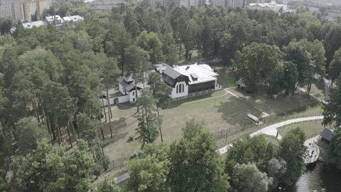 Aerial Orbit over Forest House near River