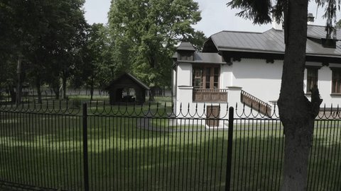 Drone Flying Sideways beside Historic House Building