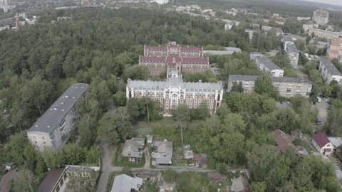 Drone Descending above Historic Brick Building Roofs