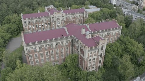 Drone Circling above Historic Brick Building Roof