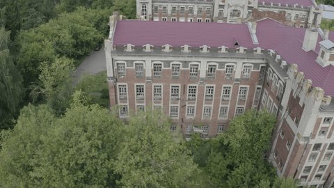 Side Drone Flight Past Historic Brick Building