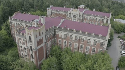 Drone Rising above Old Architectural Complex