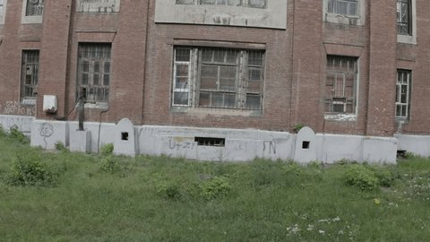 Drone Rising beside Historic Industrial Architecture