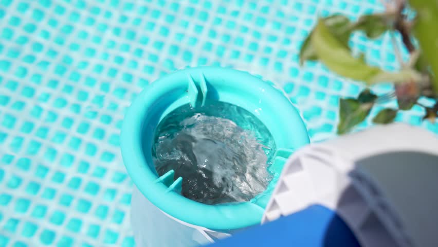 A pool filter return sends water swirling into a bright blue pool. Bubbles, ripples, turquoise color, sunlight, and clean summer maintenance define the scene.