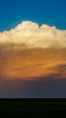 Golden evening light spreads across the sky as storm clouds begin to clear, creating dramatic contrast, rich atmospheric colour, calm post storm ambience and a striking scene after severe weather passes
