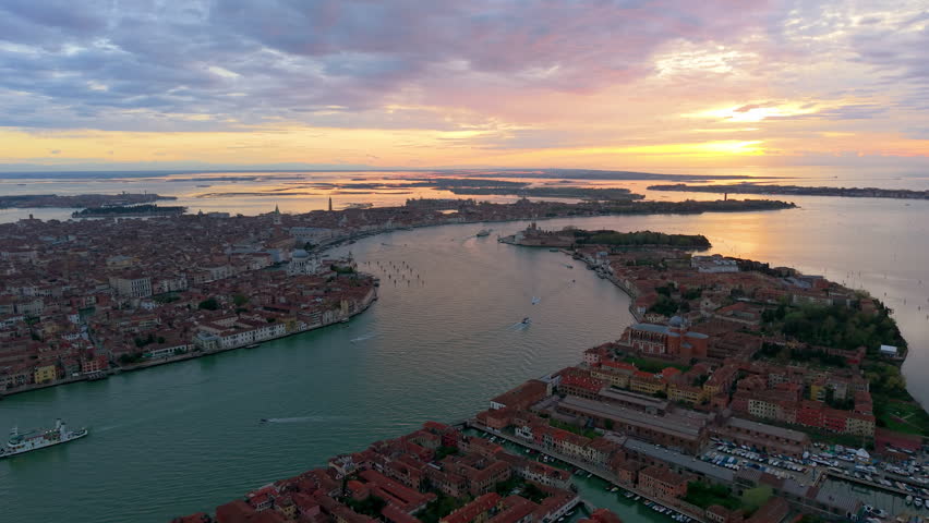 Venice evening sights. Sunset over Venice waterways. Twilight scene with gondolas and historic bridges. Italy