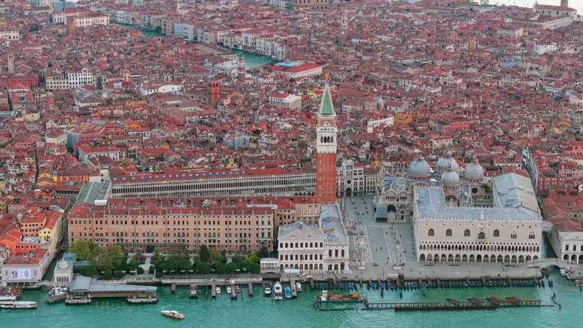 Venice evening sights. Sunset over Venice waterways. Twilight scene with gondolas and historic bridges. Italy