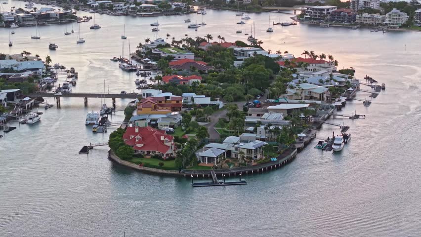 Sunshine Coast, Queensland Australia, waterfront homes, canal island, luxury houses, sunset aerial, drone photography, waterways, canal estate, private jetty, marina lifestyle, coastal suburb, palm trees, luxury real estate, waterfront property, boating lifestyle, river canals, residential island, scenic sunset, Australian coast, upscale neighborhood, holiday destination, waterside living, aerial landscape, coastal homes