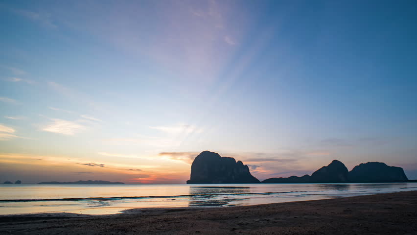Time-lapse of late evening sky over an exotic beach, transitioning from dusk to darkness in Thailand.