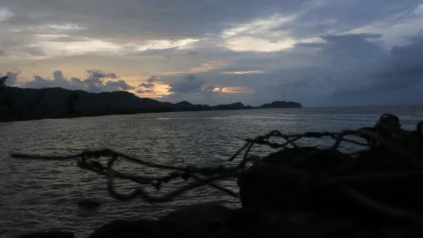 sunset with moving clouds  in the dark sky 