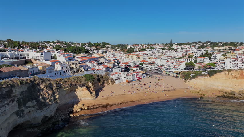 Aerial view of the little town Carvoeiro built on rocky cliffs along the ocean shoreline in Algarve, Portugal, Europe.