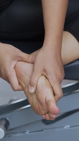 Women while exercising touching painful twisted or broken foot. Athlete training. Sport sprained sprain cause injury. and pain with bones. Plantar fasciitis symptoms.	