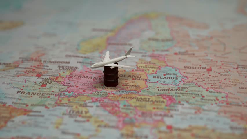 Toy aircraft on barrel atop Europe map.