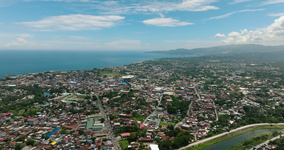 Iligan City with residential area in riverside. Northern Mindanao, Philippines. Cityscape.