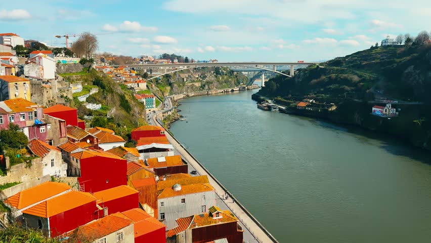 View of Douro River with terracotta rooftops and upstream bridges Vila Nova de Gaia and Porto Portugal