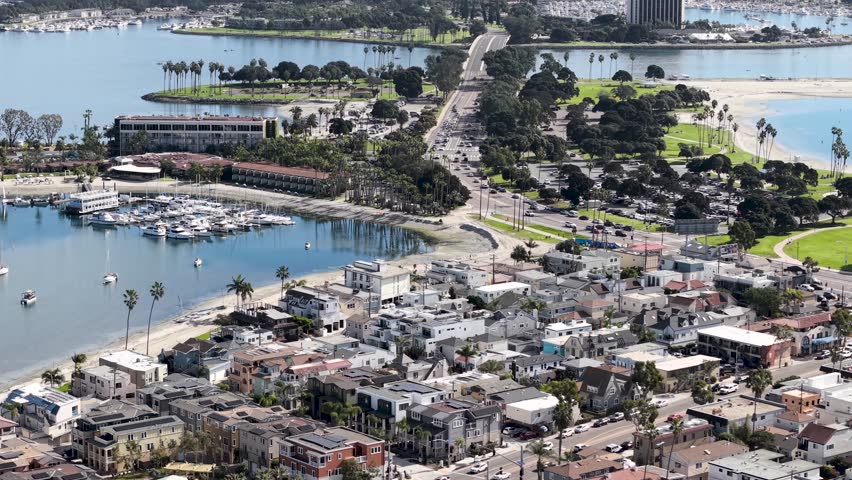 San Diego cityscape from Mission Bay. View of the bay to the full downtown city skyline and neighborhoods, California. Sea World Theme Park Rollercoasters.
