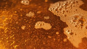 Abstract top view macro texture of golden oil with foam bubbles and sparkling reflections. Viscous liquid background for food, cosmetic or industrial concepts. - Powered by Shutterstock - Get 15% off with code: PIKWIZARD15