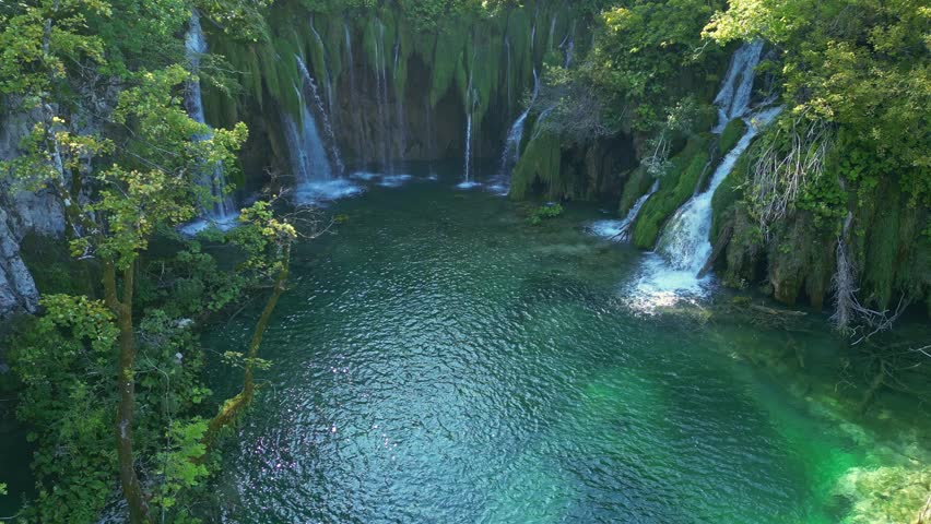 Beauty nature with waterfall. Panoramic aerial view of waterfalls. Beauty green nature. Plitvice lakes and Waterfall. Beauty waterfall landscape in Croatia. Crystal-clear water in Plitvice.