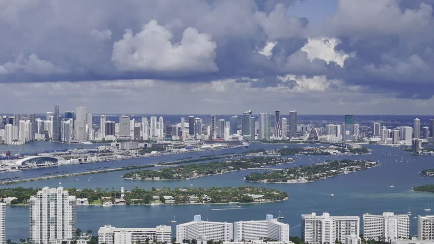 Aerial skyline of Miami Beach, Florida at sunset with bay, highrise buildings and dramatic clouds. g.