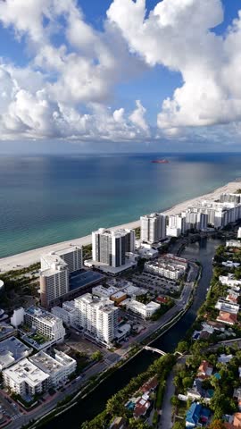 Aerial skyline of Miami Beach, Florida at sunset with bay, highrise buildings and dramatic clouds. g.