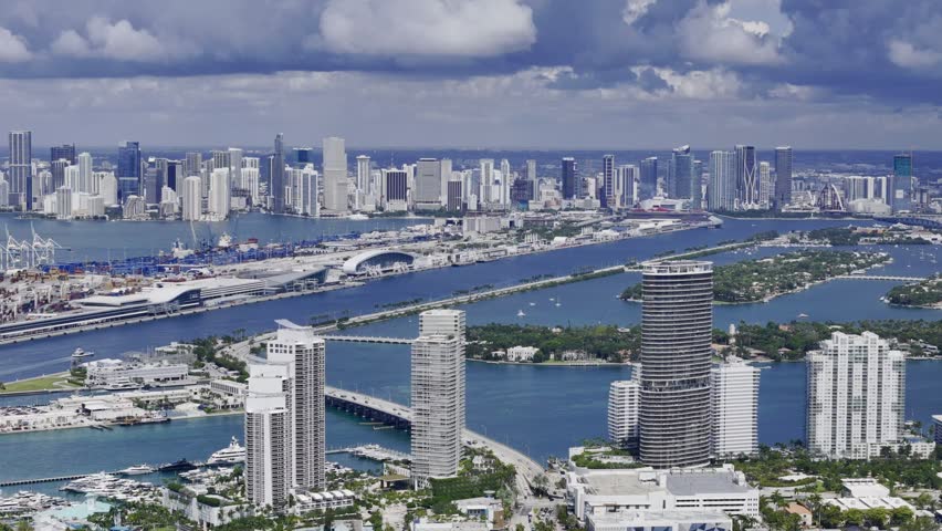 Aerial skyline of Miami Beach, Florida at sunset with bay, highrise buildings and dramatic clouds. g.