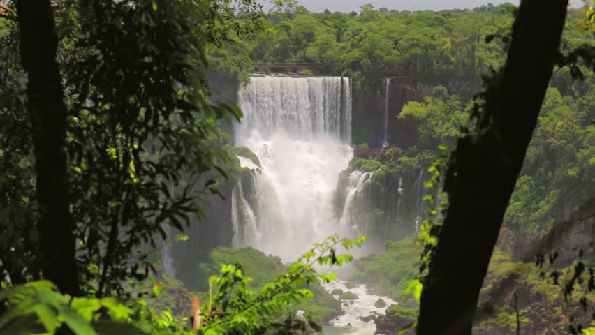 Majestic Iguazu Falls seen through the lush green jungle on border of Brazil and Argentina
