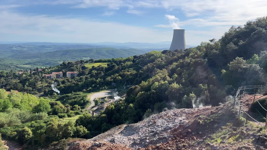 Geothermal steam rising over forest valley
