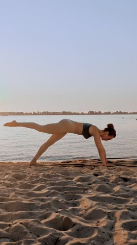 Barre workout. stretching outdoors. yoga beach. Athletic young woman is doing exercises on mat, at the beach during sunset or sunrise. Fitness training outdoors. Fitness, ballet, sport, yoga
