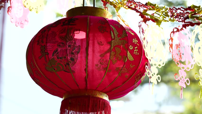 Traditional red Chinese lantern with golden decorative characters meaning fortune happiness and prosperity in English. Festive hanging ornament used during Chinese celebration.