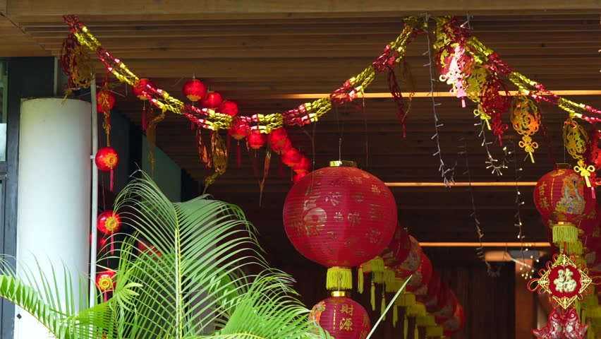 Traditional red Chinese lantern with golden decorative characters meaning fortune happiness and prosperity in English. Festive hanging ornament used during Chinese celebration.