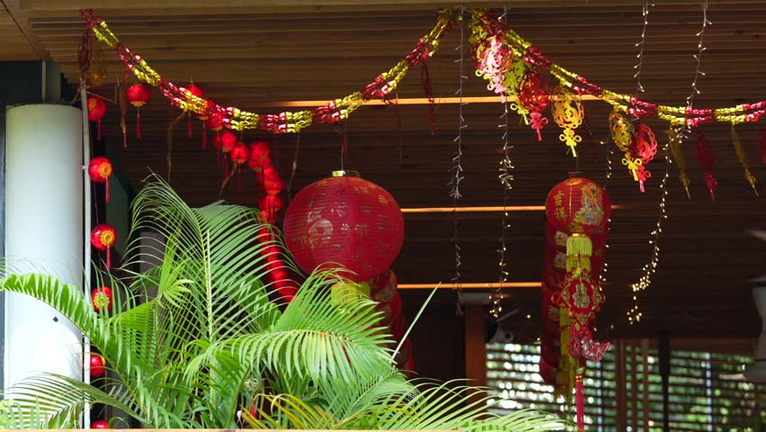 Traditional red Chinese lantern with golden decorative characters meaning fortune happiness and prosperity in English. Festive hanging ornament used during Chinese celebration.