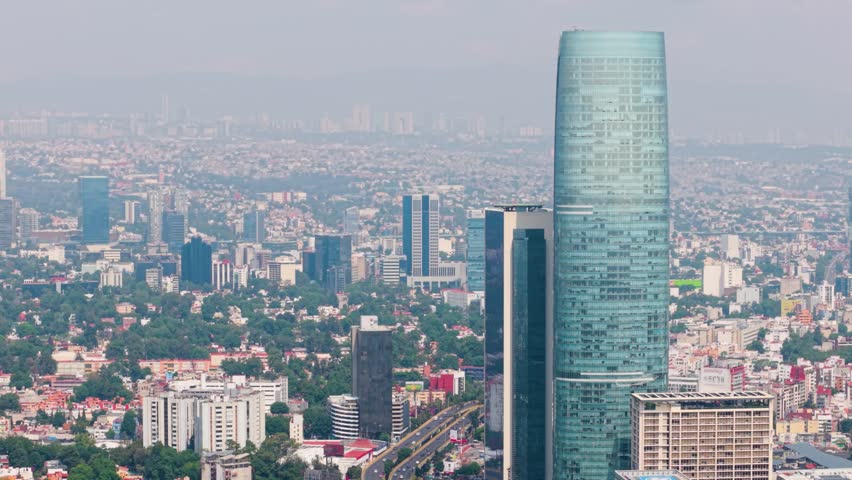 Elevated aerial of Mexico City covered in smog from highest tower perspective