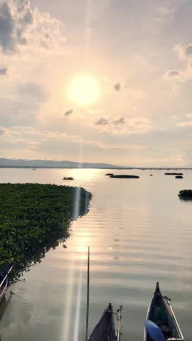 Sunset Over Water With Boats and Greenery