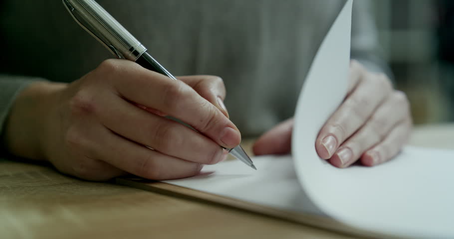 Woman is signing the documents