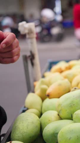 Trading Cash Amid Fruit Marketplace. Exchanging Currency During Lively Outdoor Fruit Market Negotiations. Financial Exchange Taking Place Amidst Outdoor Fruit Selling And Bargaining Activities