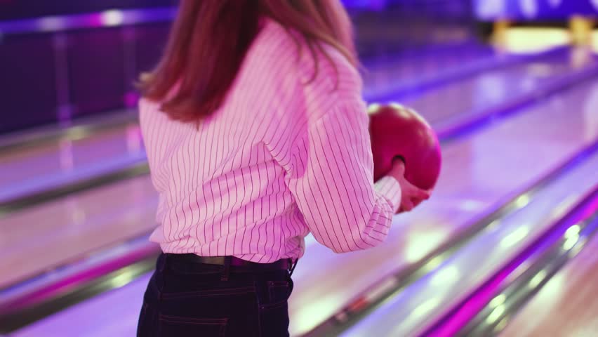 Bowling club play, group team of friends and colleagues playing, throwing a ball on the bowling alley lane, ball and pins, corporate party event in a mall amusement game center, tournament competition
