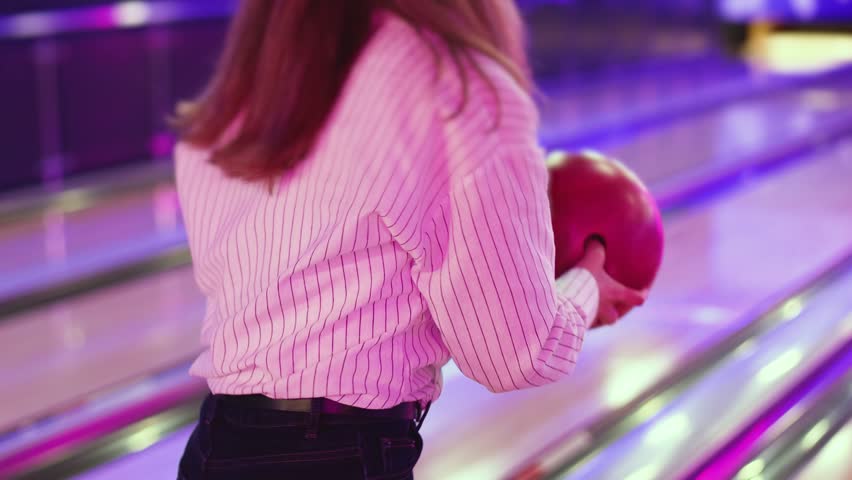 Bowling club play, group team of friends and colleagues playing, throwing a ball on the bowling alley lane, ball and pins, corporate party event in a mall amusement game center, tournament competition