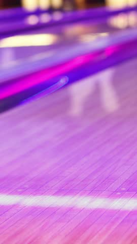 Bowling club play, group team of friends and colleagues playing, throwing a ball on the bowling alley lane, ball and pins, corporate party event in a mall amusement game center, tournament competition