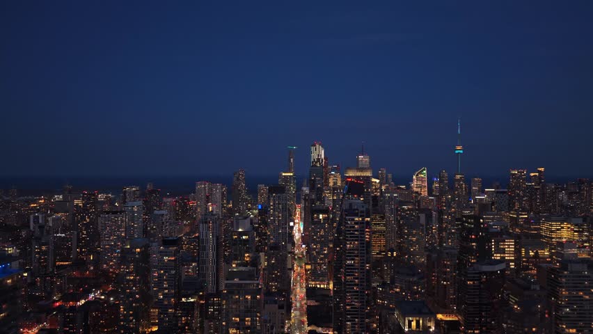 Aerial pull back shot between two skyscrapers in Toronto