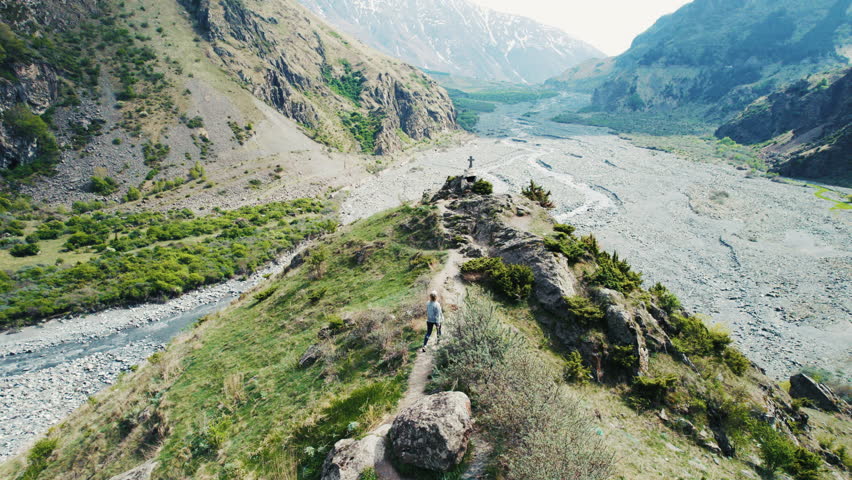 Hiker walking on a mountain ridge trail