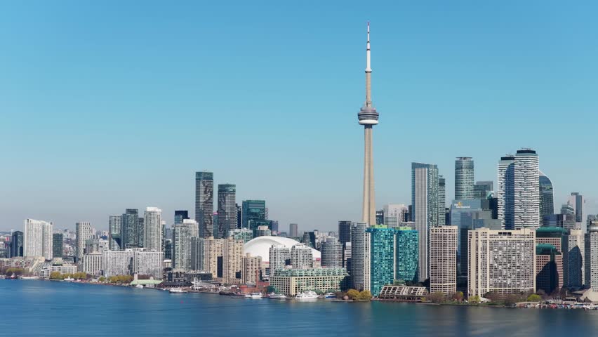Soaring cityscape showcasing downtown Toronto skyline with CN Tower and financial district buildings along Lake Ontario with urban metropolitan landscape