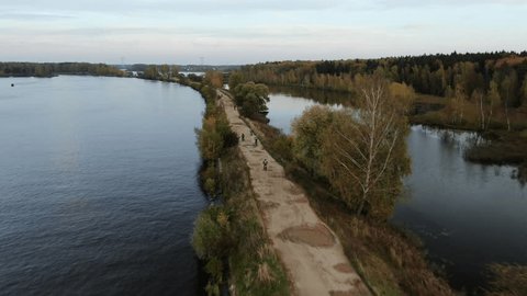 Forward Tracking Drone over Bikers by River