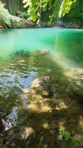 Hidden waterfall and lagoon in green wilderness forest